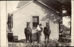 Man Holding Baby and Horses Postcard