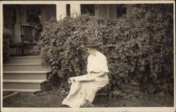 Woman Reading in Front of Home Postcard