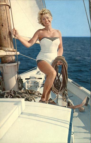 Woman in White Bathing Suit Holding Rope on Sailboat