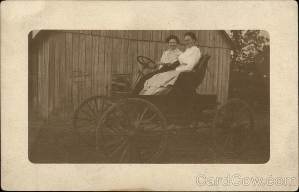 Two Women Driving Old Auto