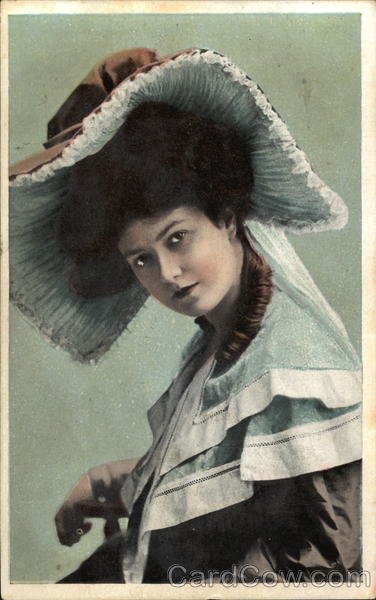 Dark Haired Woman Wearing Large Brown and Cream Hat