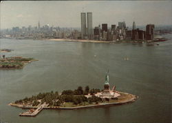 Liberty Island and the Manhattan Skyline New York, NY Postcard Postcard