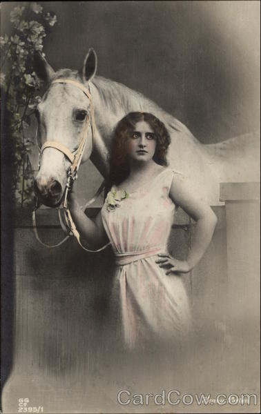 Woman Standing by a Fence with a White Horse Horses