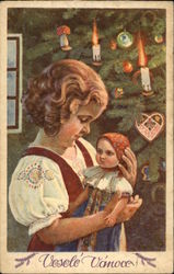 Little Girl Holding Doll beside Christmas Tree Postcard