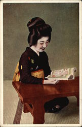 Japanese Woman Smiles While Looking at Illustrated Booklet Postcard