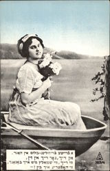 Woman Sitting in Row Boat holding Flowers Woman Sitting in Row Boat holding Flowers