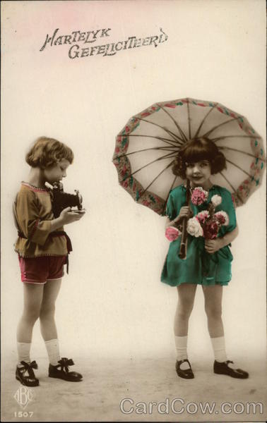 Hearty Congratulations - Two Girls with Camera, Flowers, and Umbrella