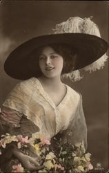 Photograph of Woman in Large Plumed Hat holding Flowers Postcard
