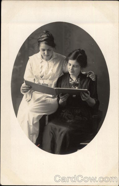 Two Women Peruse an Album
