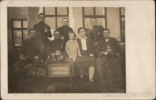 A Group of Soldiers with Drinks and a Woman and Child