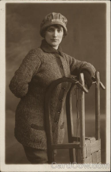 Woman in Winter Attire Posing with Sled Women