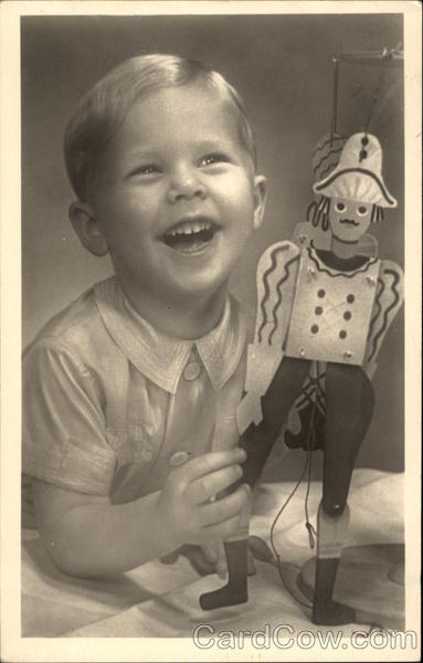 Young Blonde Boy Laughing with his Toy Boys