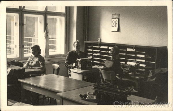 Man and Two Women using Typewriters in an Office Setting