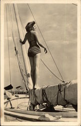 Photograph of Bathing Beauty standing on Sail Mast Postcard