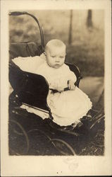 Vintae Photograph Infant Wearing White sitting in a Black Pram Postcard