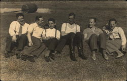 Group of Men Sitting on Grass Postcard