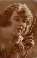 Beautiful Woman holding Rose while gazing into Hand Mirror Art Deco Postcard Postcard