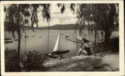 Woman by the Waterfront with Sailboats Postcard Postcard