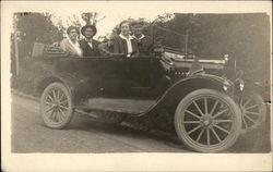 Two Couples sitting in Vintage Automobile Postcard