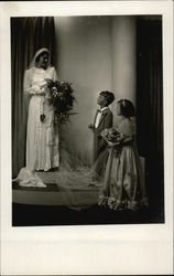Bride holding Bouquet with Young Attendants Bride holding Bouquet with Young Attendants