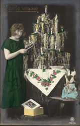 Woman in Green Lighting Candles on Christmas Tree Postcard