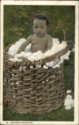 "Southern Products" - a Black Baby sitting in a Basket of Cotton Postcard