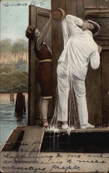 Woman in red swim suit pouring water over man in white
