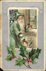 Santa in blue/green suit holding bag of toys Postcard