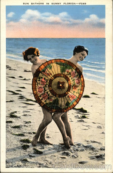 Two Women Behind Umbrella on Beach Florida