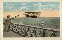 The Aeroplane Flying Past the End of one of the Ocean Piers Postcard