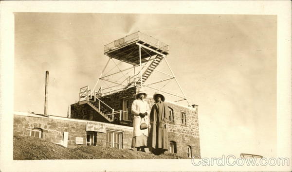 Two Women Posing In Front of Large Brick Building