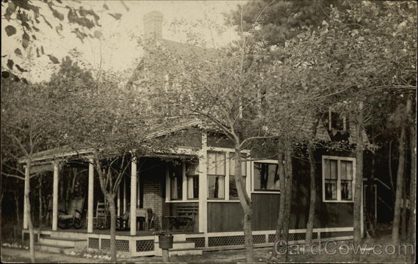 House with porch, surrounded by trees Harwich Port Massachusetts