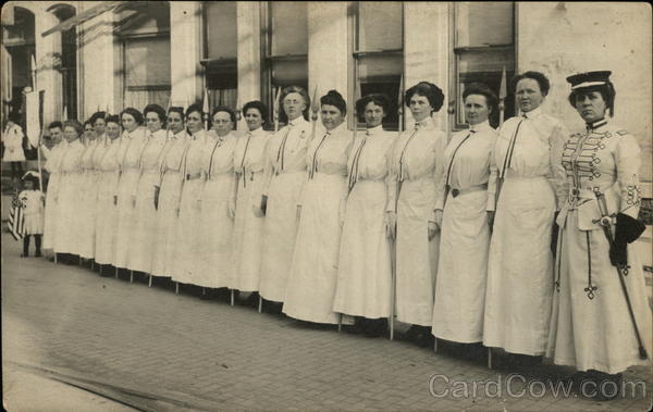 Women in white dresses standing in a row