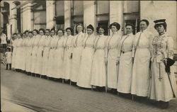 Women in white dresses standing in a row Postcard