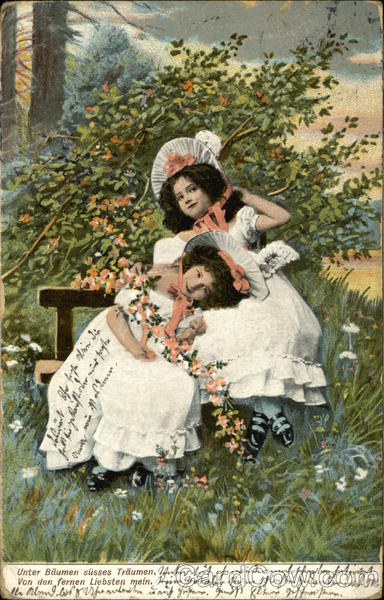 Two Little Girls in White Ruffled Dresses Hold Orange Flowers and Sit on Bench