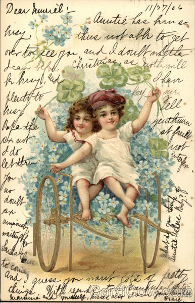 Two Children Riding Cart of Flowers
