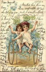 Two Children Riding Cart of Flowers Postcard