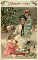 Christmas Greetings with Mother and Children by the Tree Postcard