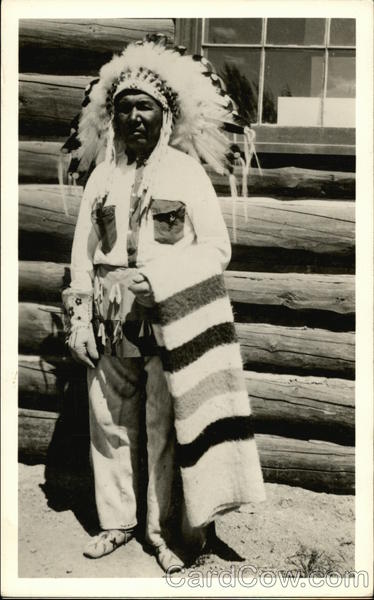 Native American in Headdress, Holding Striped Blanket