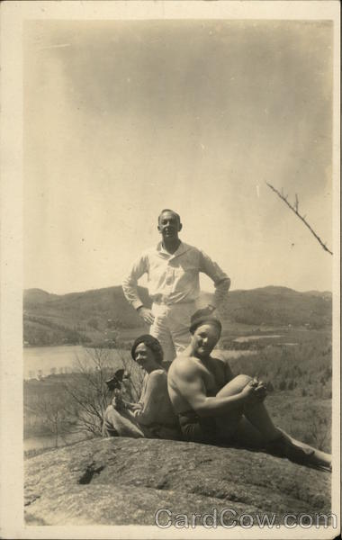 Two Men and Woman Posing on Hill