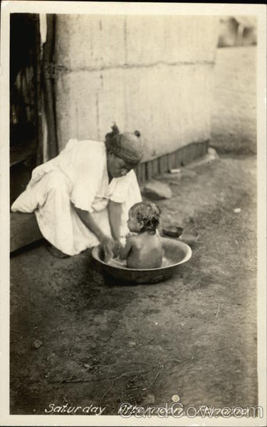 Woman Bathing a Child in the Street - Panama