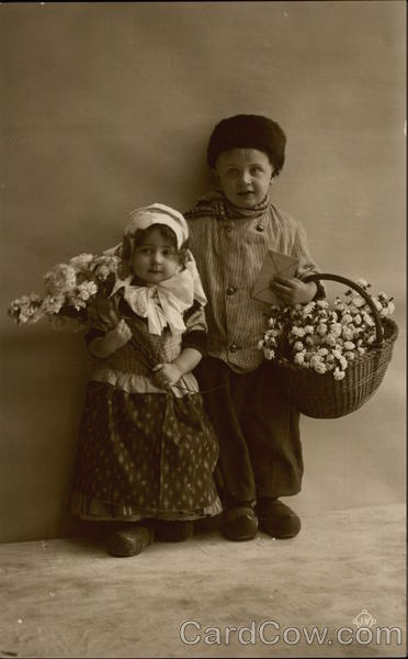Portrait of Two Children Holding Flowers