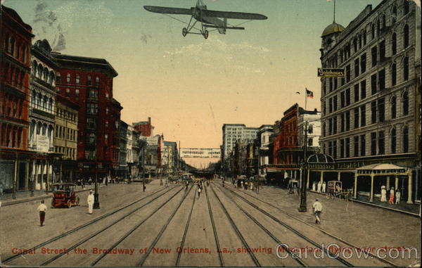 Canal Street, the Broadway of New Orleans, La. showing monoplane flying over street Louisiana