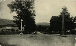 Photo of a intersection of dirt roads in a small town Postcard