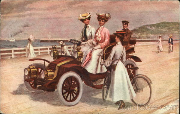 Women riding an early-era automobile share the road with bicyclists