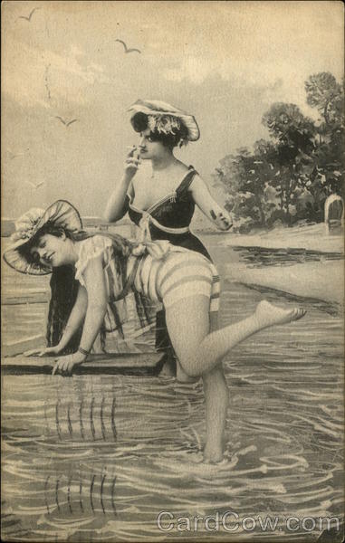 Women playing in the water, and smoking, at the beach.