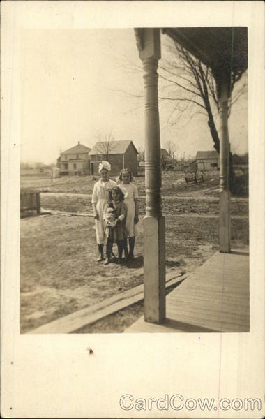 Family photo of three girls in front of their home in the early 20th century Van Wert Ohio