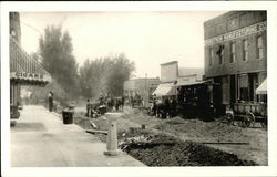 Men laying railroad ties through the city Cromwell, IN Postcard Postcard