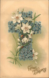 Blue flowers in a cross arrangement with White Lillies and Butterflies Postcard
