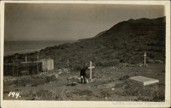 Man at a Cross in a Graveyard by Ocean California